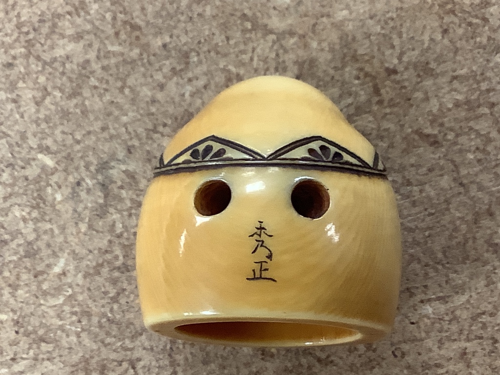 A Japanese gilt lacquered ivory vase, 11.2cm high, a 19th century ivory cup and ball game and an ivory netsuke of Daruma